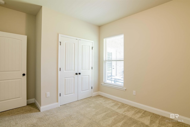 6902 Summerset Dr, Gulf Shores, AL 36542 - unfurnished bedroom with carpet floors, a closet, and baseboards