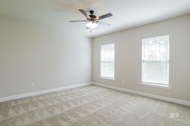 6902 Summerset Dr, Gulf Shores, AL 36542 - spare room featuring light colored carpet, baseboards, and ceiling fan
