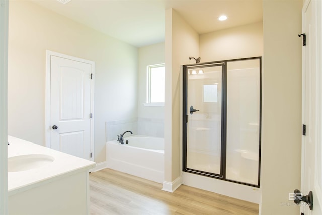 6902 Summerset Dr, Gulf Shores, AL 36542 - full bath with a stall shower, a garden tub, wood finished floors, baseboards, and vanity
