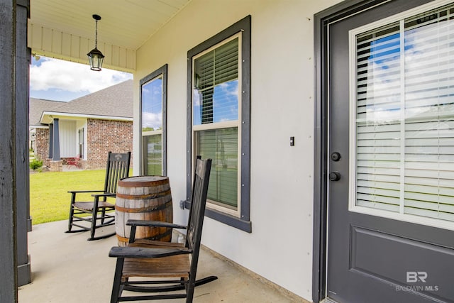 6902 Summerset Dr, Gulf Shores, AL 36542 - doorway to property with a porch, stucco siding, and a yard