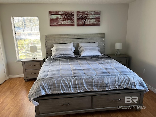 bedroom with light hardwood / wood-style flooring