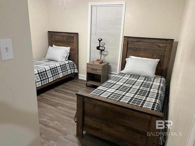 bedroom with hardwood / wood-style flooring