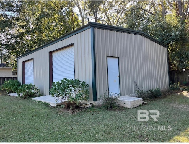 view of outbuilding featuring a garage and a lawn