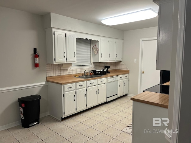 kitchen featuring light tile patterned flooring, tasteful backsplash, white cabinetry, dishwasher, and sink