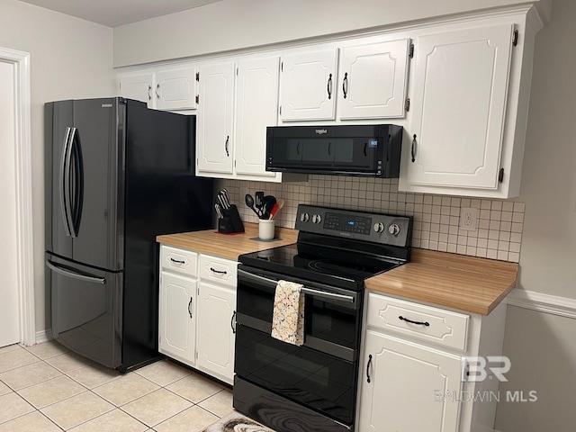 kitchen with tasteful backsplash, white cabinetry, light tile patterned floors, and black appliances