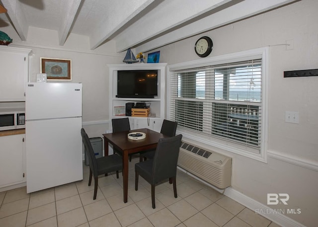 dining space featuring beam ceiling, a wall unit AC, a textured ceiling, and light tile patterned flooring