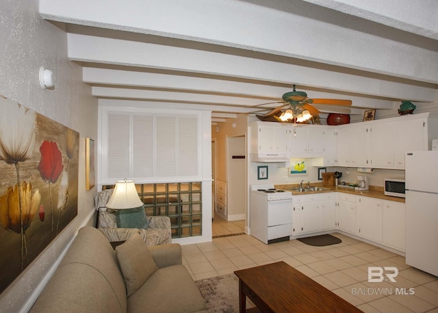 kitchen featuring sink, white appliances, light tile patterned floors, ceiling fan, and white cabinets