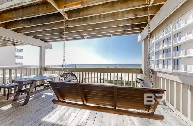 deck with a beach view and a water view