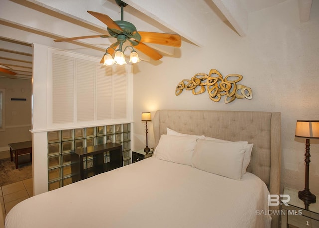 bedroom with ceiling fan, beam ceiling, and tile patterned flooring