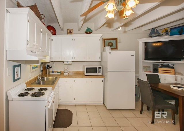 kitchen with sink, white appliances, light tile patterned floors, beam ceiling, and white cabinets