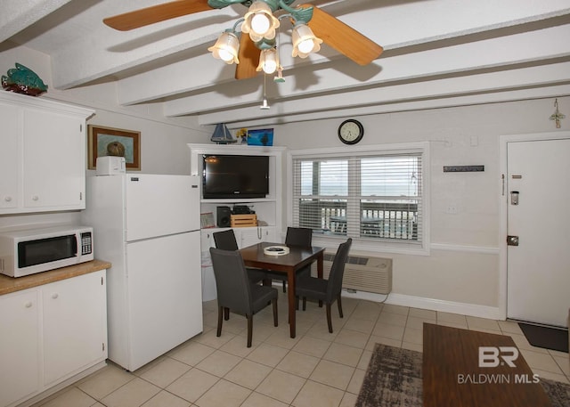 tiled dining room with beamed ceiling and a wall unit AC