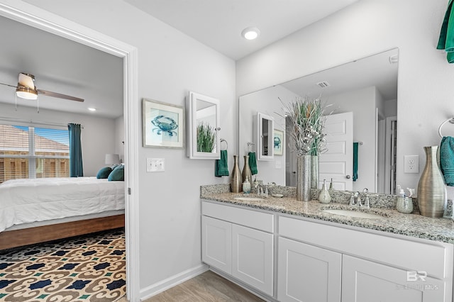 20770 Mercury Dr, Robertsdale, AL 36567 - bathroom with ensuite bathroom, double vanity, a ceiling fan, and wood finished floors
