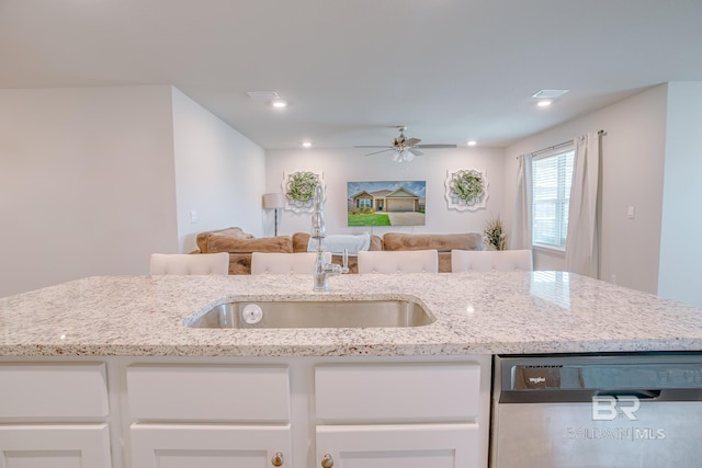 8242 Sycamore Way, Semmes, AL 36575 - kitchen with stainless steel dishwasher, open floor plan, white cabinets, light stone countertops, and recessed lighting