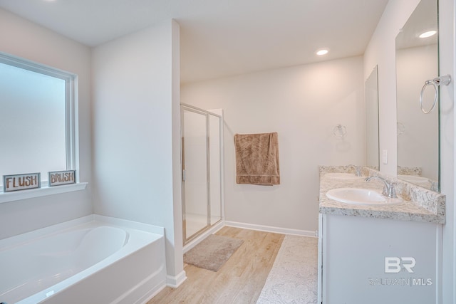 8242 Sycamore Way, Semmes, AL 36575 - full bathroom with a bath, double vanity, a shower stall, wood finished floors, and recessed lighting