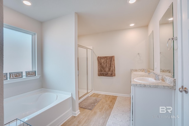 8242 Sycamore Way, Semmes, AL 36575 - full bathroom featuring double vanity, a bath, wood finished floors, a shower stall, and recessed lighting