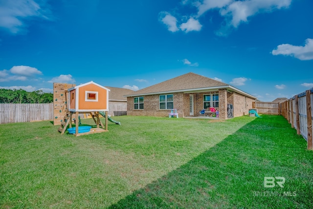 8242 Sycamore Way, Semmes, AL 36575 - rear view of house with a playground, a fenced backyard, and brick siding