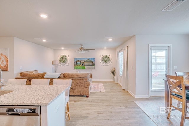 8242 Sycamore Way, Semmes, AL 36575 - kitchen featuring stainless steel dishwasher, light wood-style floors, a kitchen bar, a ceiling fan, and recessed lighting