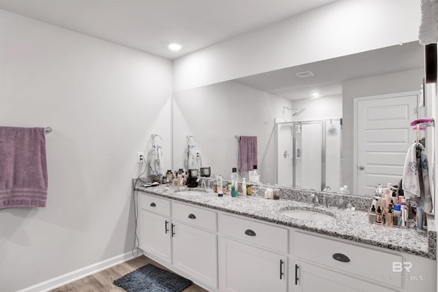 bathroom with vanity, wood-type flooring, and walk in shower