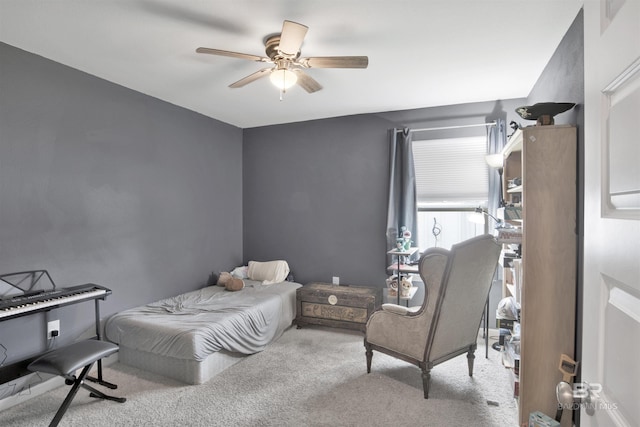 bedroom with ceiling fan and light carpet