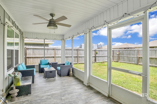 sunroom / solarium with ceiling fan and a healthy amount of sunlight