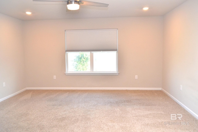 carpeted empty room featuring ceiling fan