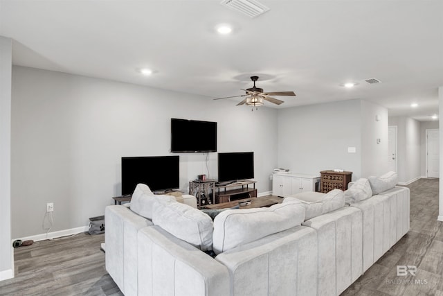 living room featuring light wood-type flooring and ceiling fan