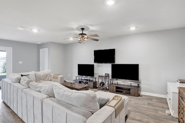 living room with ceiling fan and light hardwood / wood-style floors