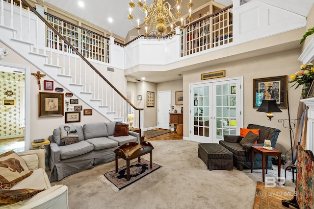 carpeted living room with french doors, a towering ceiling, and an inviting chandelier