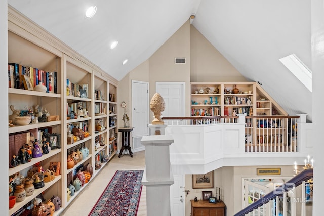 interior space with a skylight and high vaulted ceiling