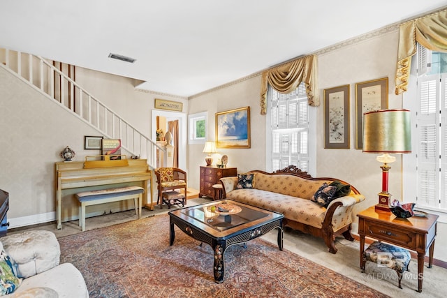 carpeted living room featuring ornamental molding