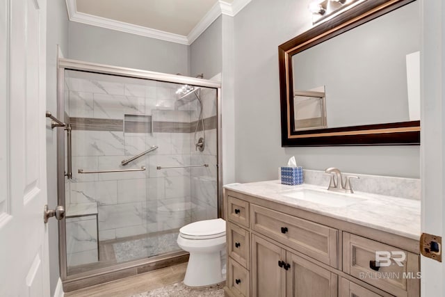 bathroom featuring vanity, toilet, walk in shower, and crown molding