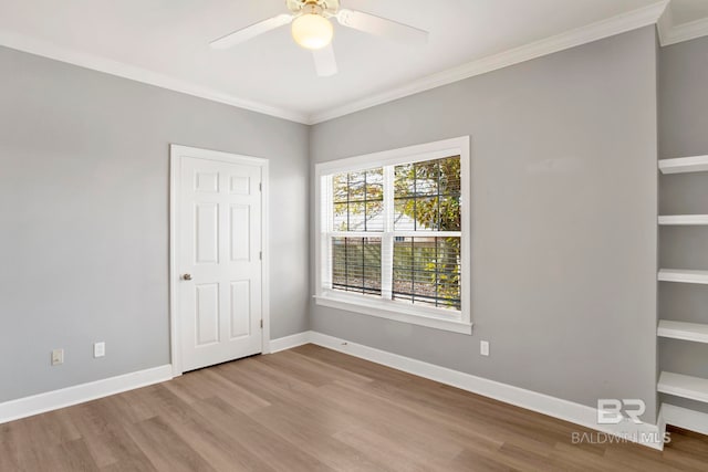 spare room featuring light hardwood / wood-style floors, ceiling fan, and ornamental molding