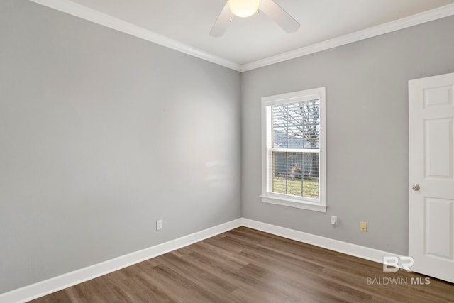 spare room featuring ceiling fan, dark wood-type flooring, and ornamental molding