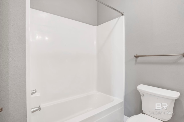 bathroom with toilet and bathtub / shower combination