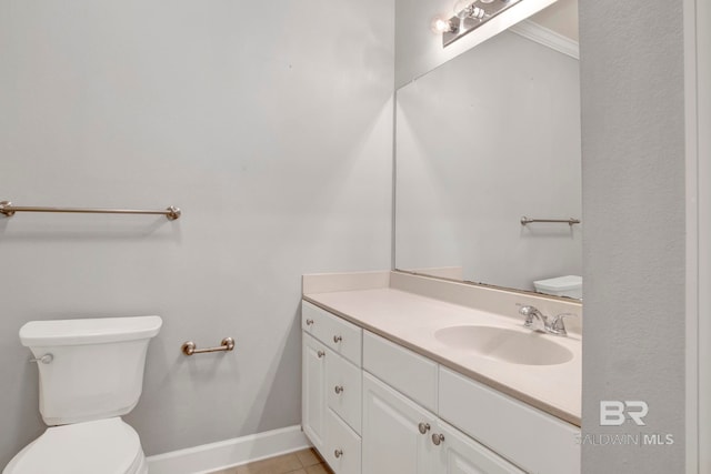 bathroom with toilet, vanity, tile patterned floors, and crown molding