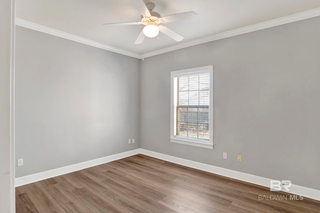 empty room with hardwood / wood-style flooring, ceiling fan, and crown molding