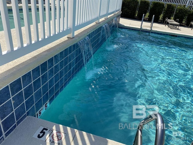 view of pool with pool water feature