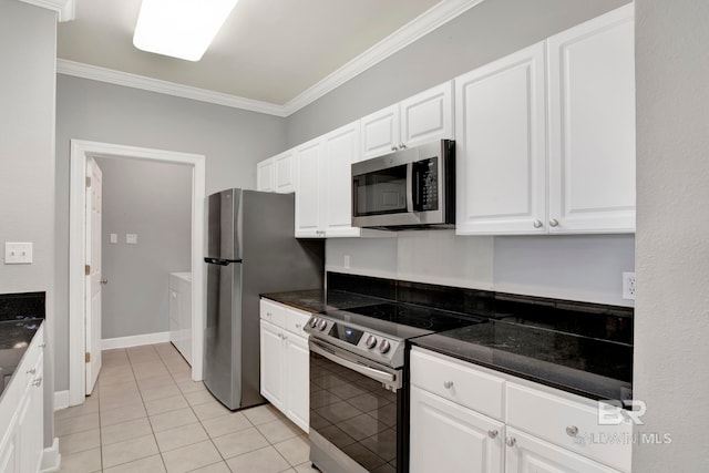 kitchen with appliances with stainless steel finishes, white cabinetry, ornamental molding, and light tile patterned flooring