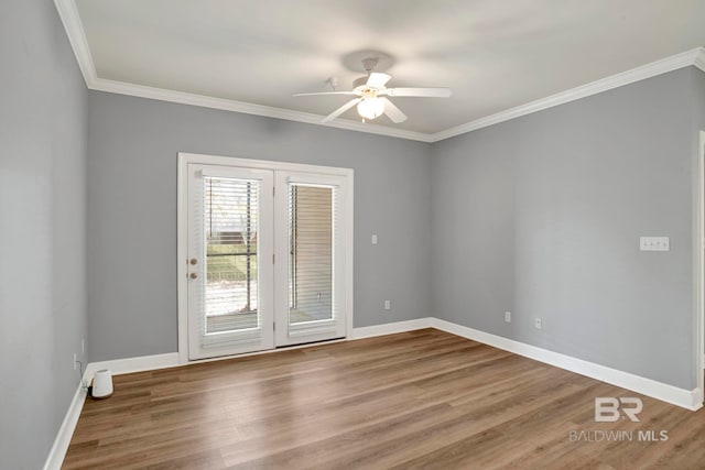 empty room with ceiling fan, wood-type flooring, and ornamental molding