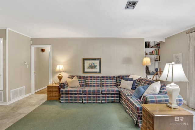 carpeted living room featuring visible vents, baseboards, and ornamental molding