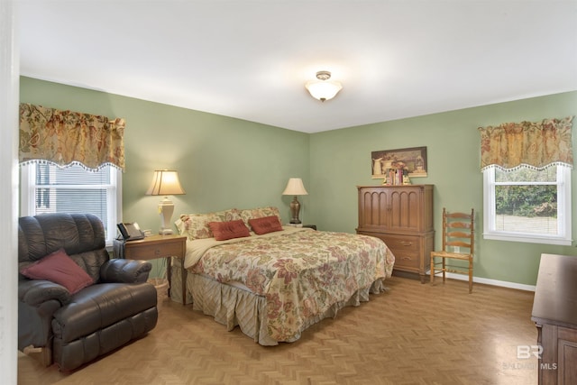 bedroom featuring multiple windows and baseboards