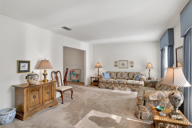 living area featuring visible vents and carpet floors