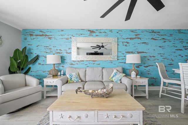 living room with ceiling fan and light wood-type flooring