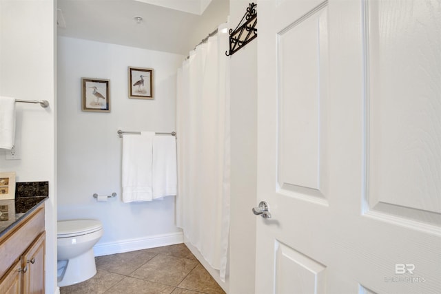 bathroom with toilet, tile patterned flooring, and vanity