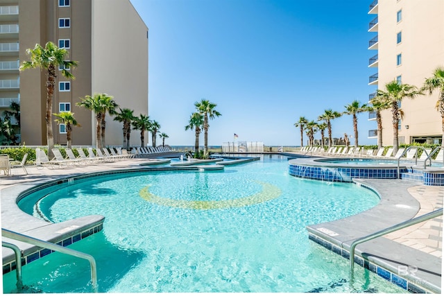 view of pool with a patio and a hot tub