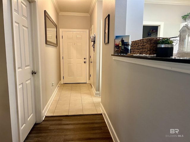 corridor featuring tile patterned flooring and crown molding