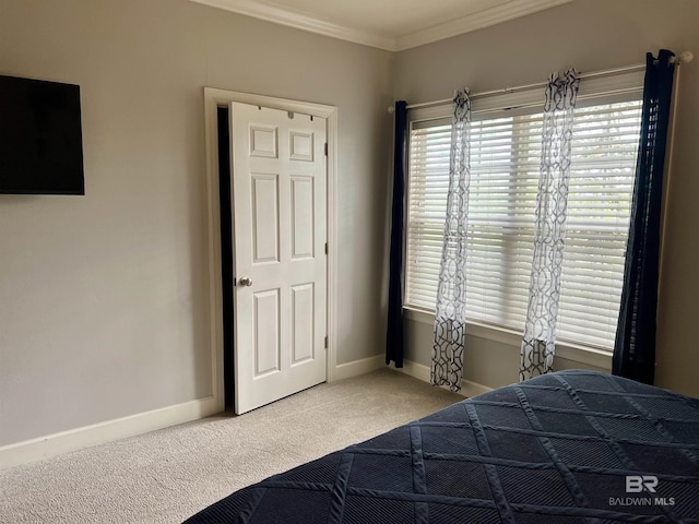 carpeted bedroom featuring crown molding