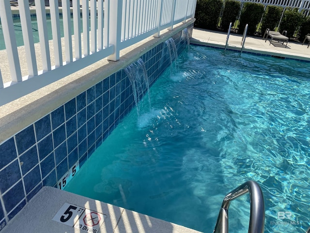 view of swimming pool featuring pool water feature