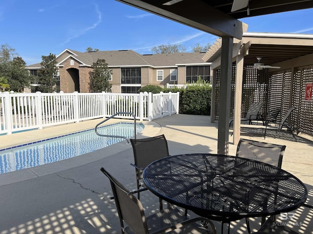 view of pool with a patio and ceiling fan