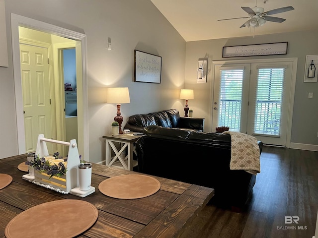 dining room with ceiling fan, dark hardwood / wood-style flooring, and vaulted ceiling